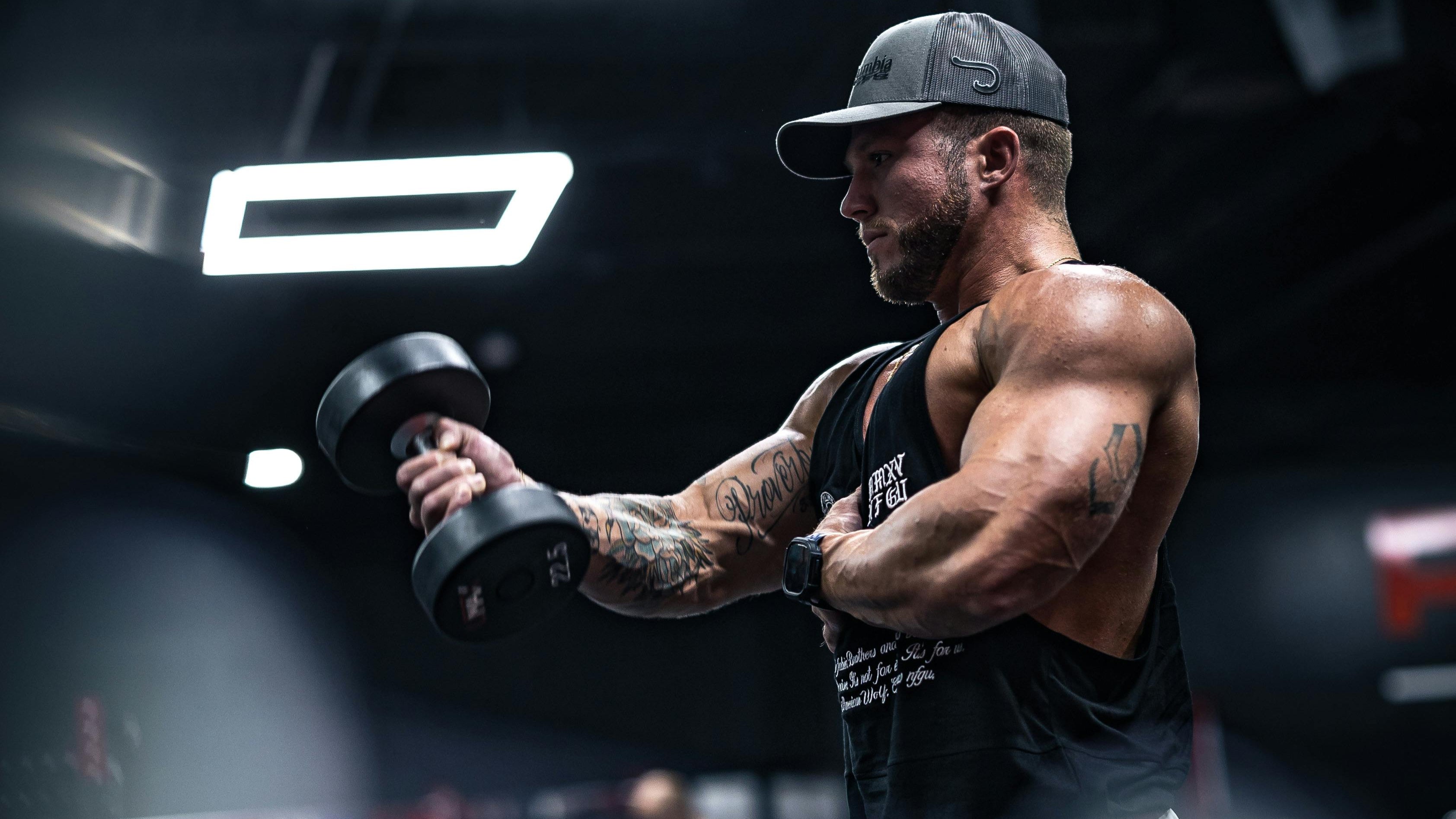 Muscular man lifting weights in a gym setting